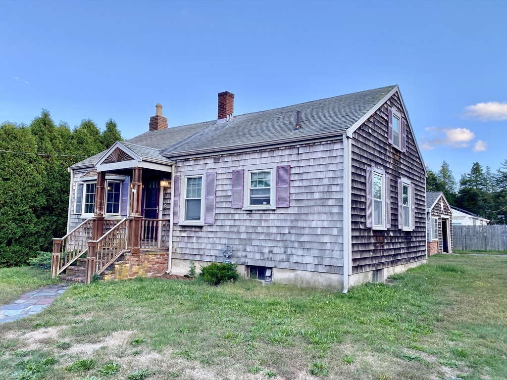 a front view of a house with a garden