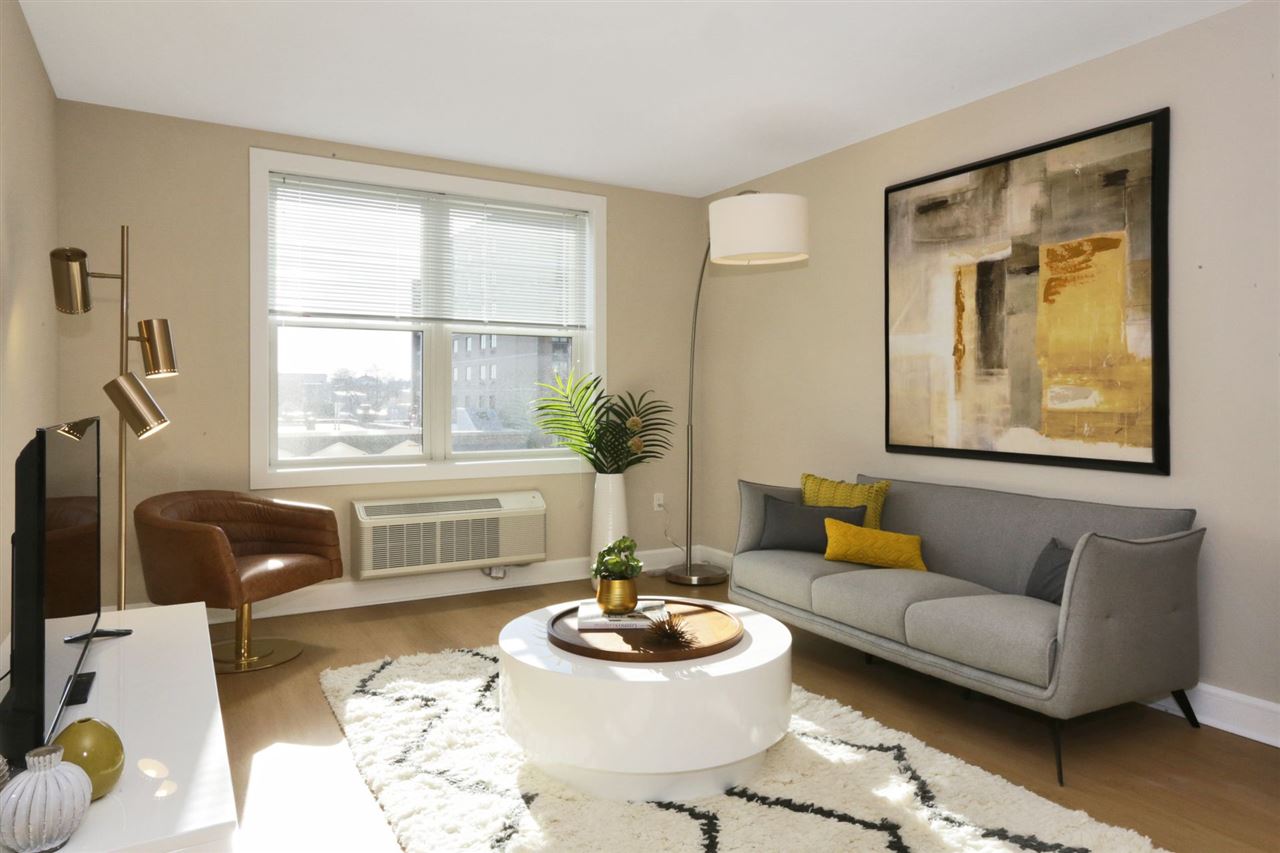 a living room with furniture and a large window