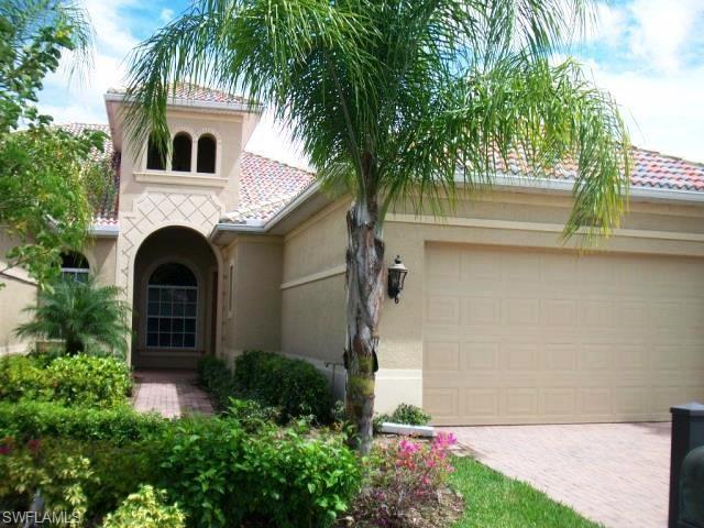 a front view of a house with plants