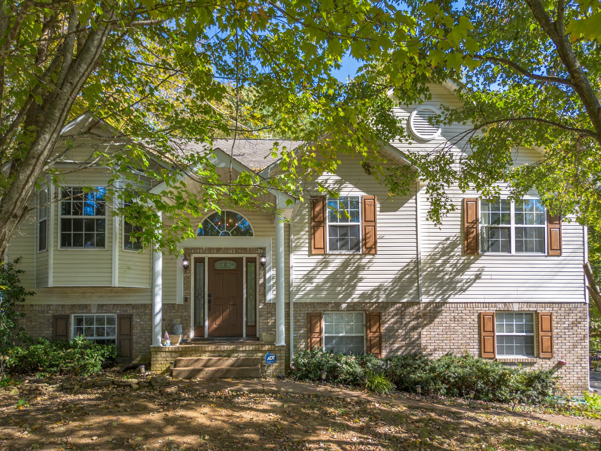 front view of a house with a tree