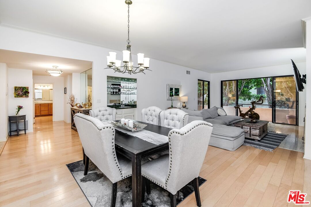 a view of a dining room with furniture wooden floor and chandelier