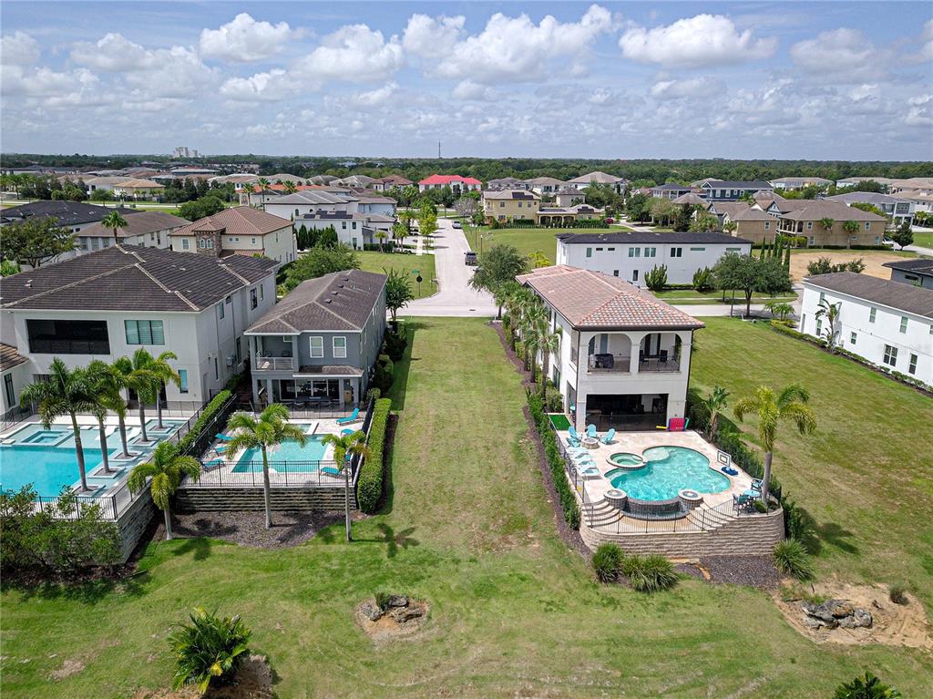 an aerial view of a house with a garden and lake view