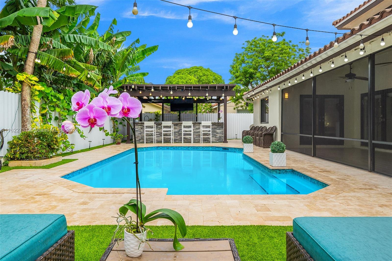 a view of a backyard with plants and a patio