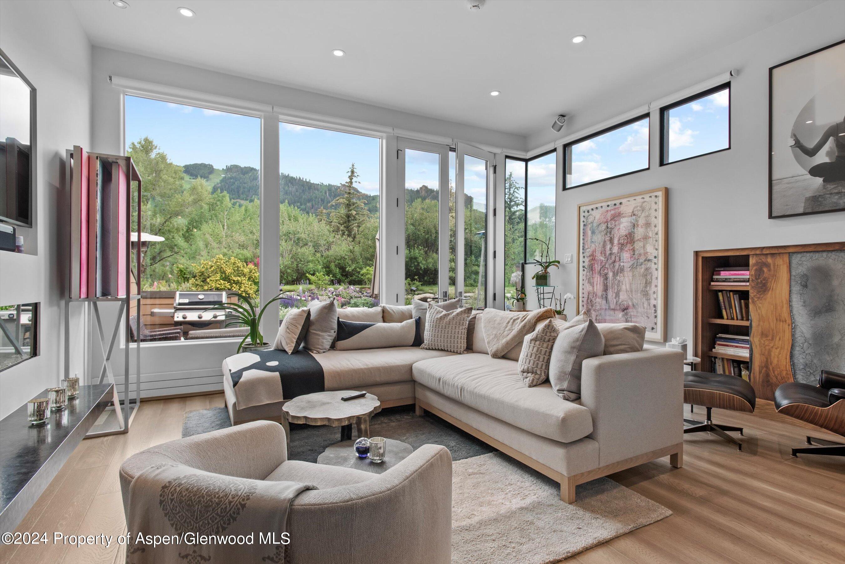 a living room with furniture tv and a large window