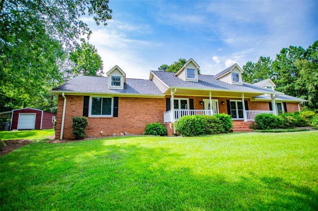 a front view of house with yard and green space