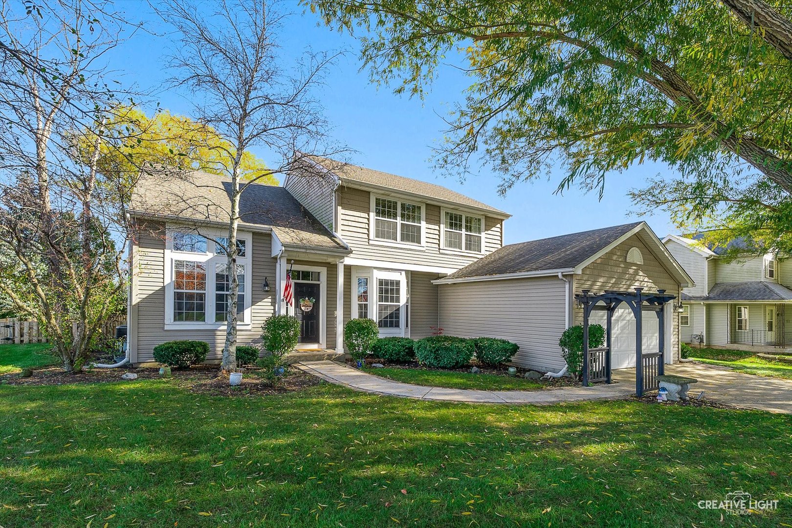 a front view of a house with plants and garden