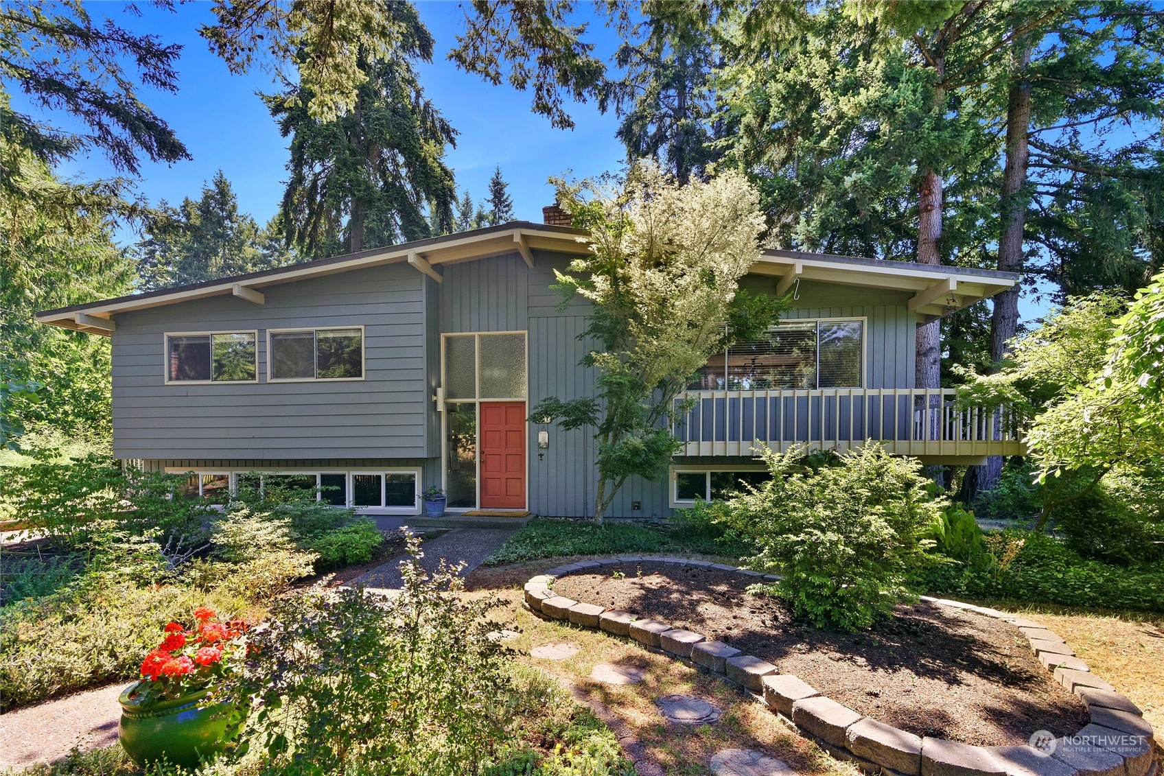 a front view of house with a garden