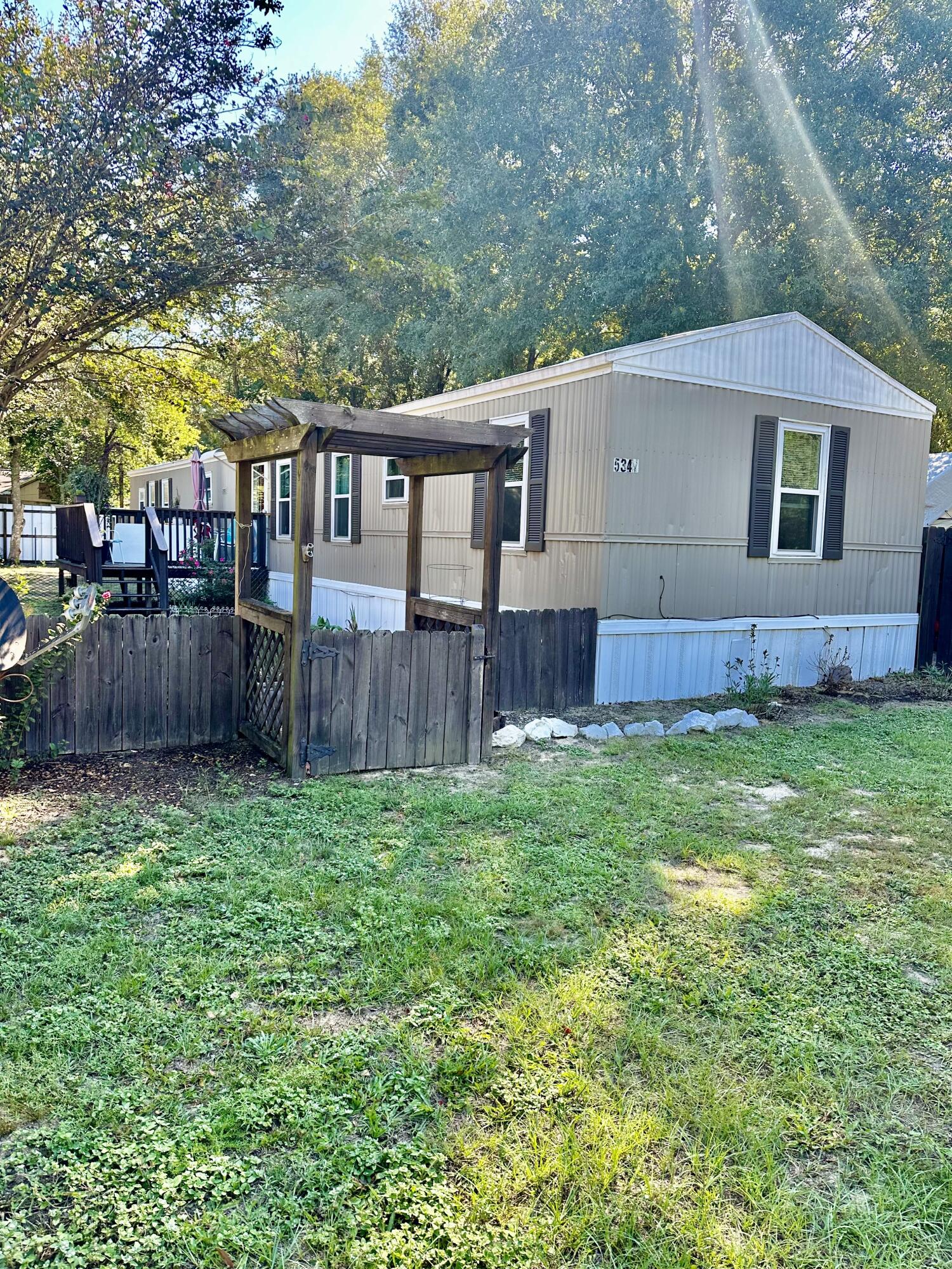 a view of a house with a yard and sitting area