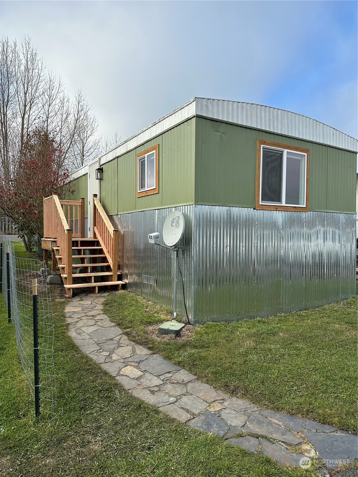 a backyard of a house with barbeque oven and a bench