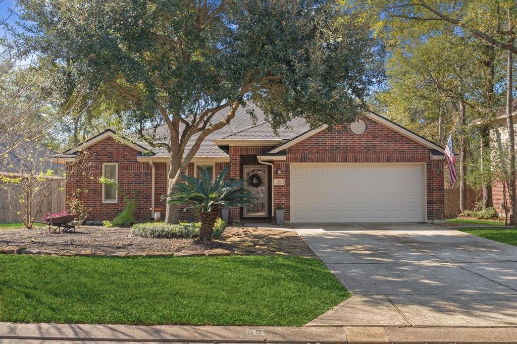 a front view of a house with a garden and yard