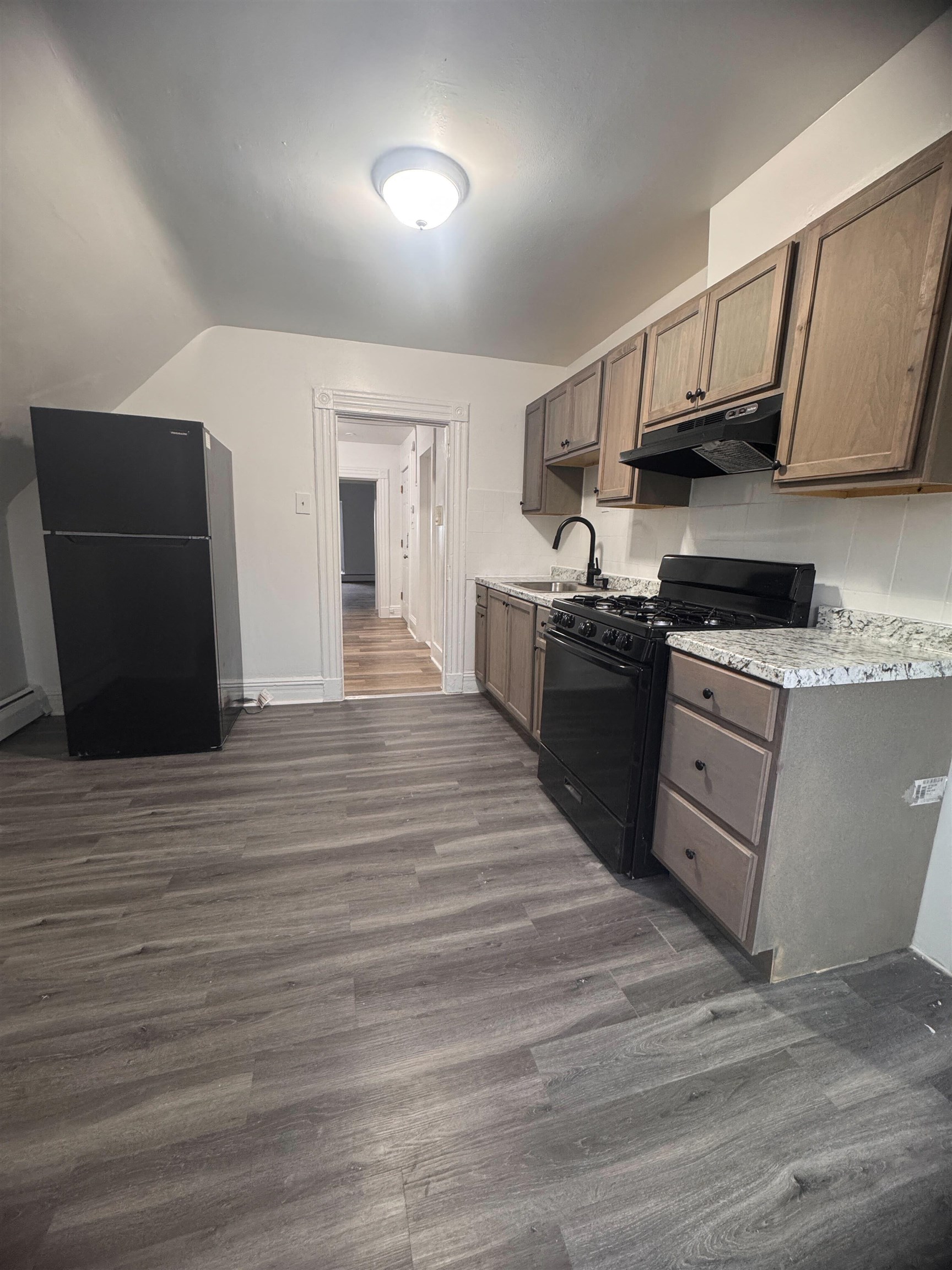 a kitchen with stainless steel appliances granite countertop a stove and a refrigerator