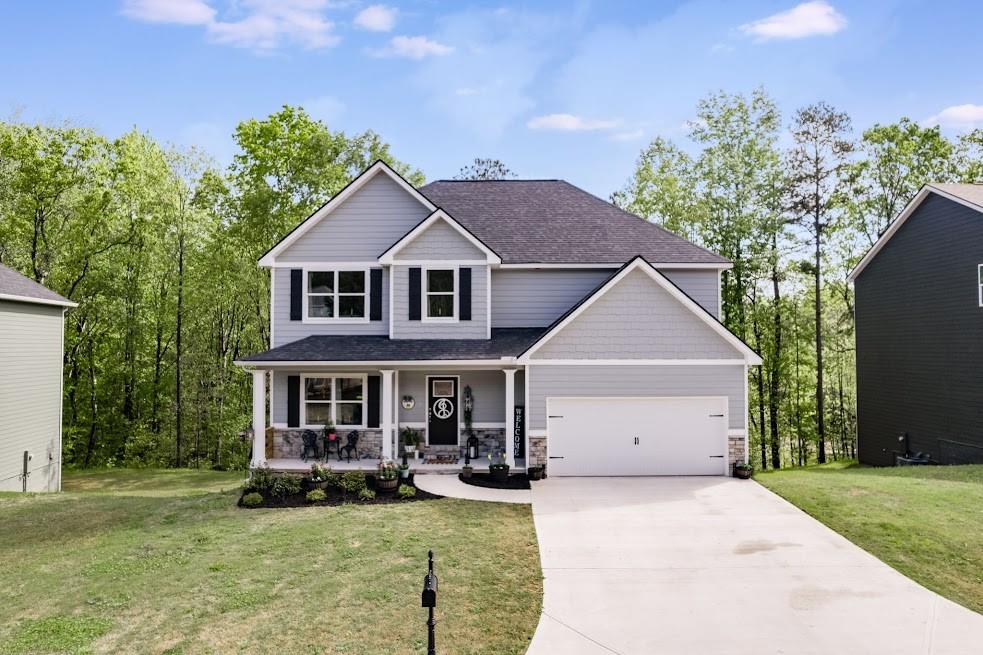 a front view of a house with yard and green space