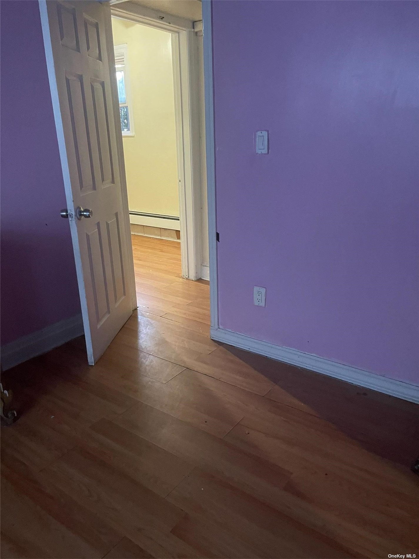 a view of a livingroom with wooden floor and a window