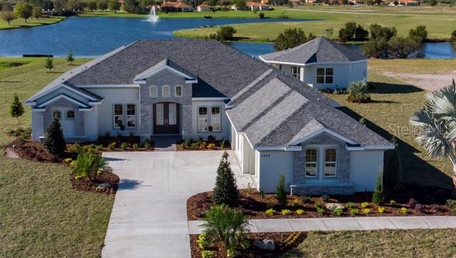 a aerial view of a house next to a yard