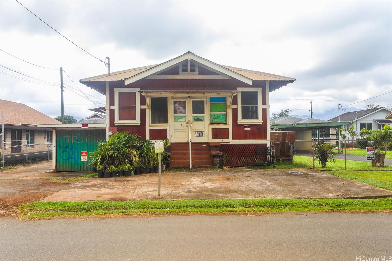 a front view of a house with a garden and plants