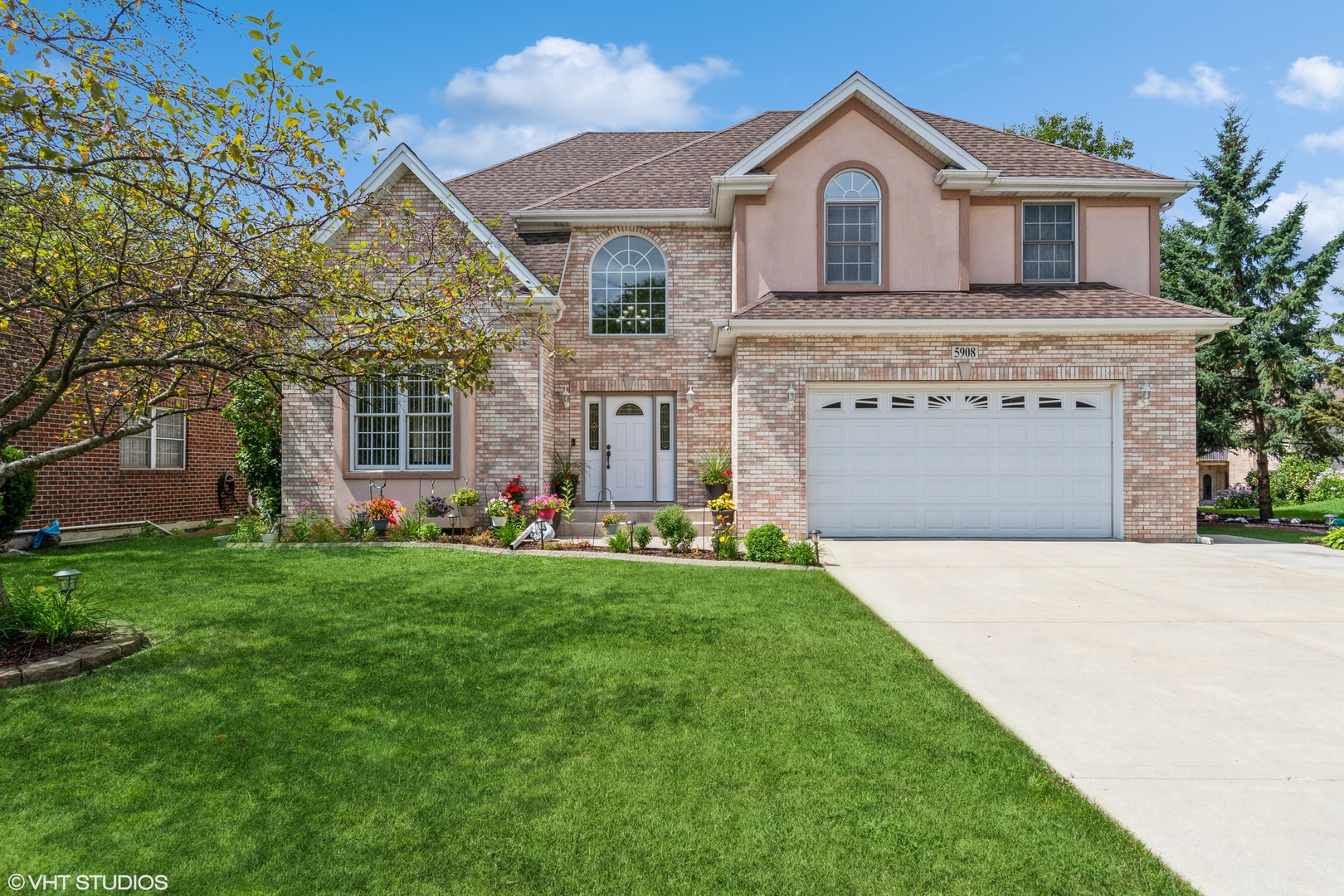 a front view of a house with a yard and garage