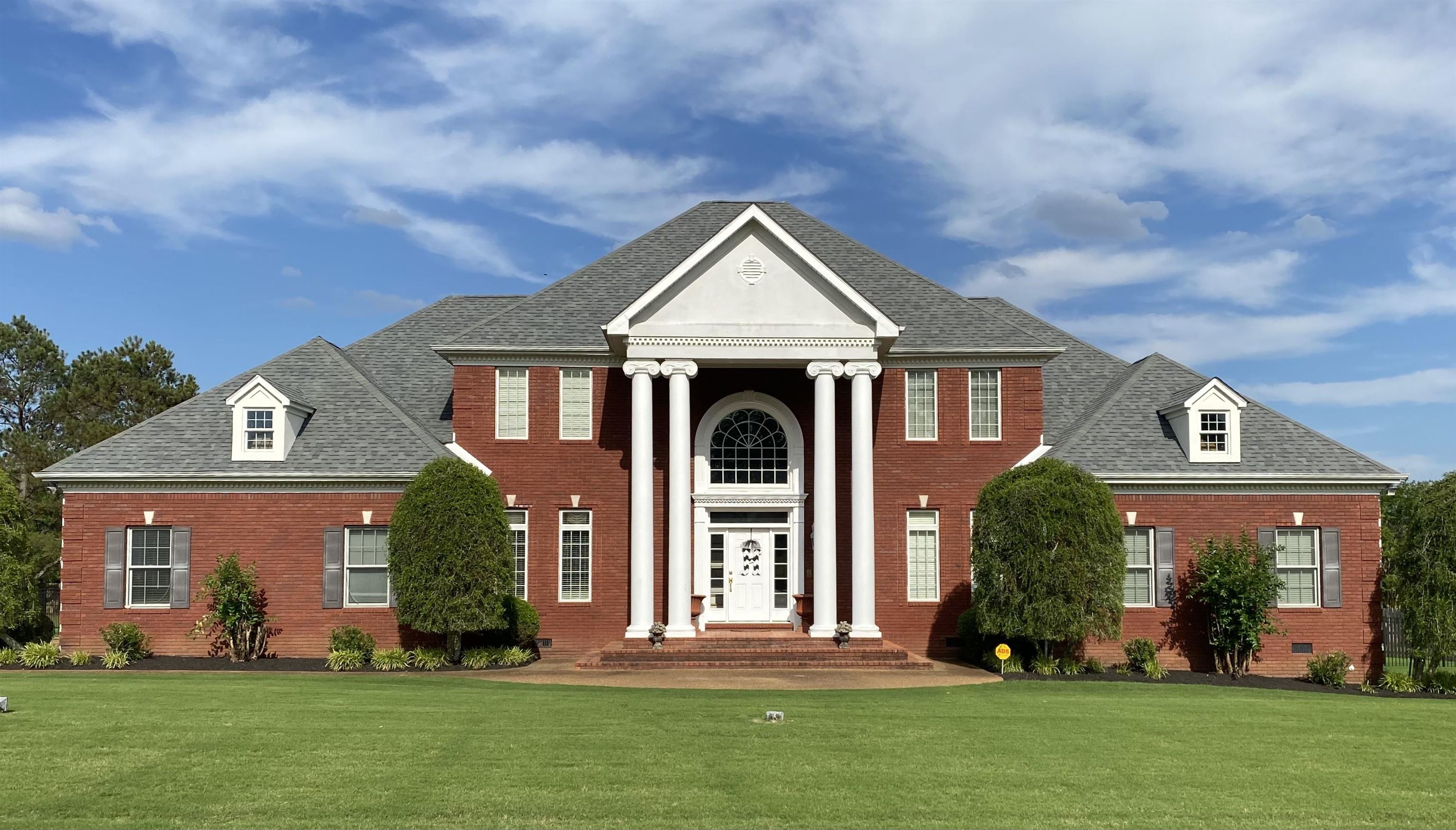 front view of a house with a yard