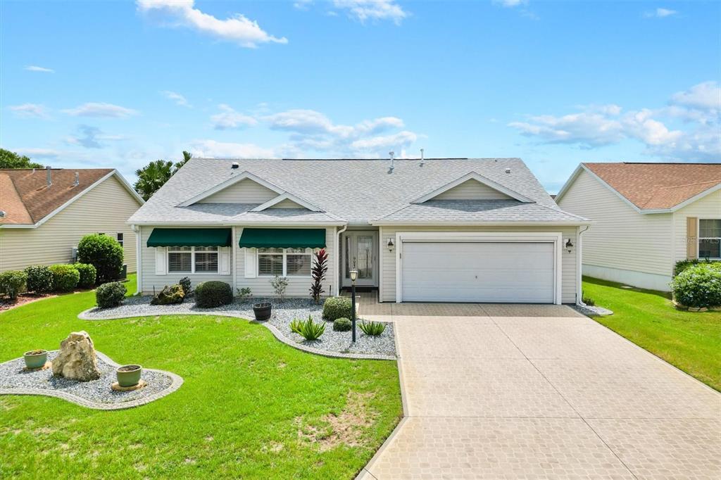 a front view of house with yard and outdoor seating