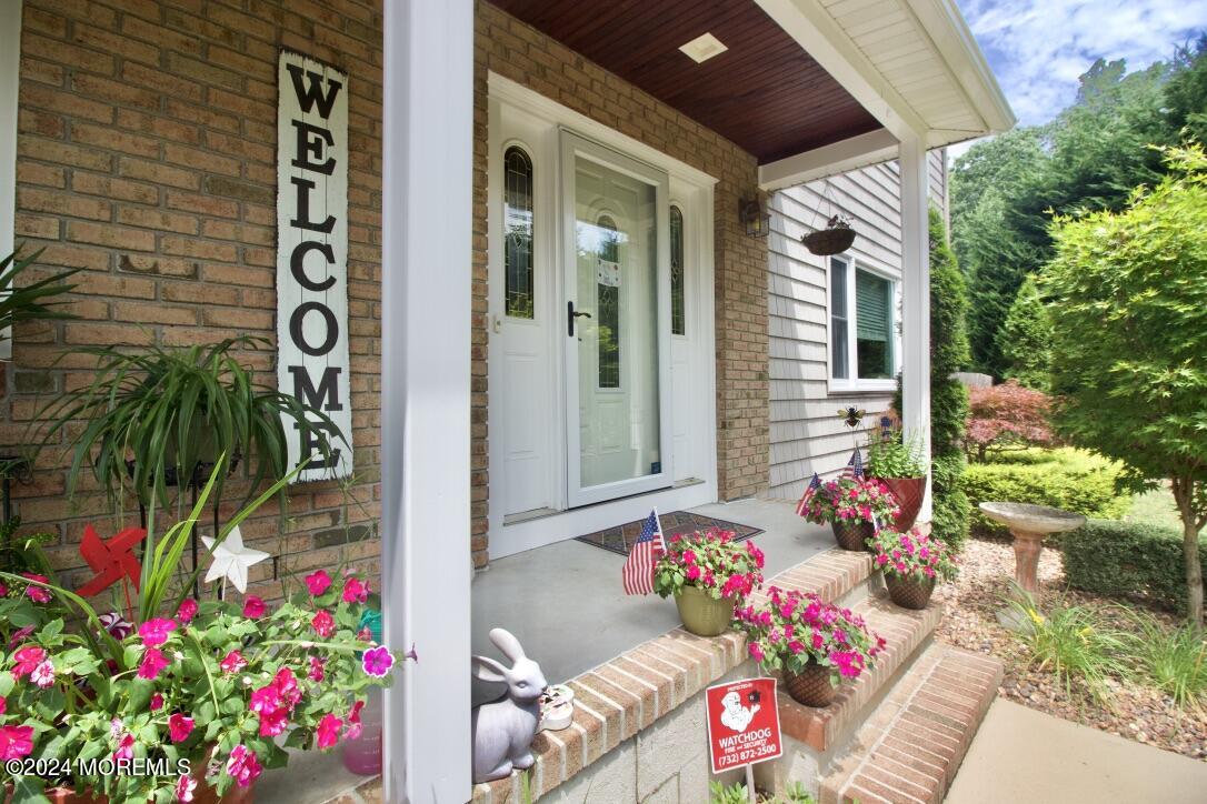 a view of front door of house and flowers