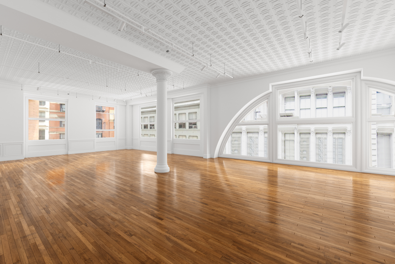 a view of empty room with wooden floor and windows