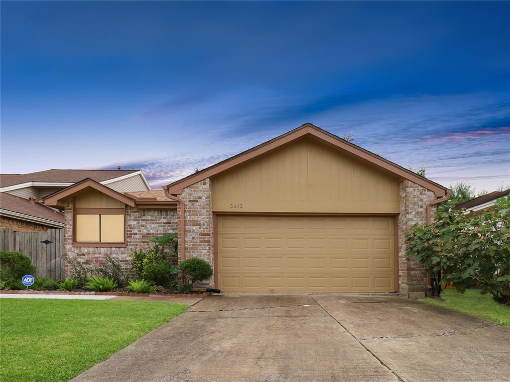 Home is a single-story, brick-faced home featuring a two-car garage and well-maintained landscaping. 