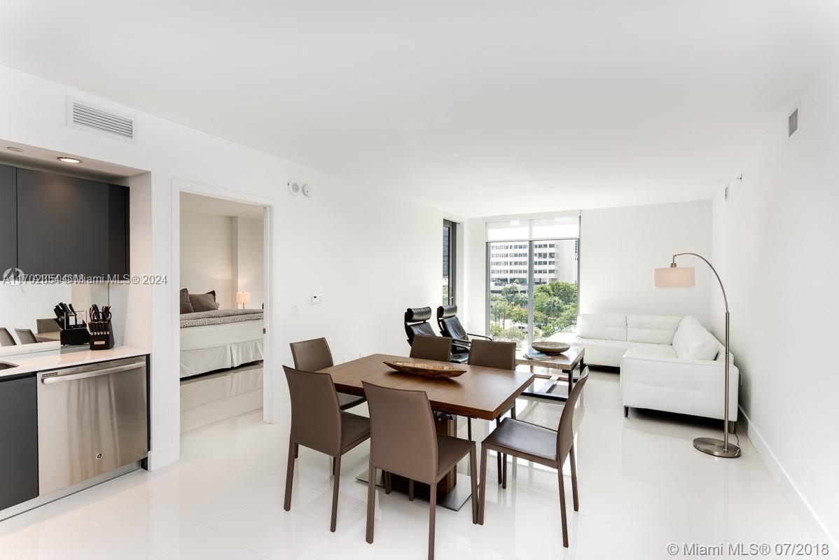 a dining room with furniture and window