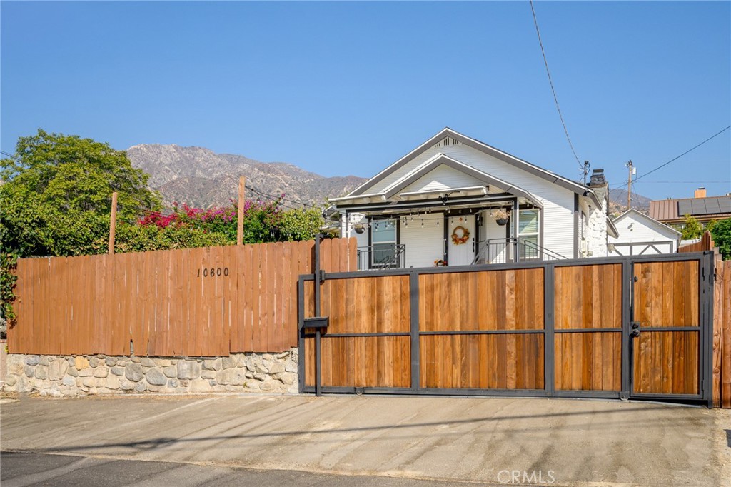 a front view of a house with a wooden fence