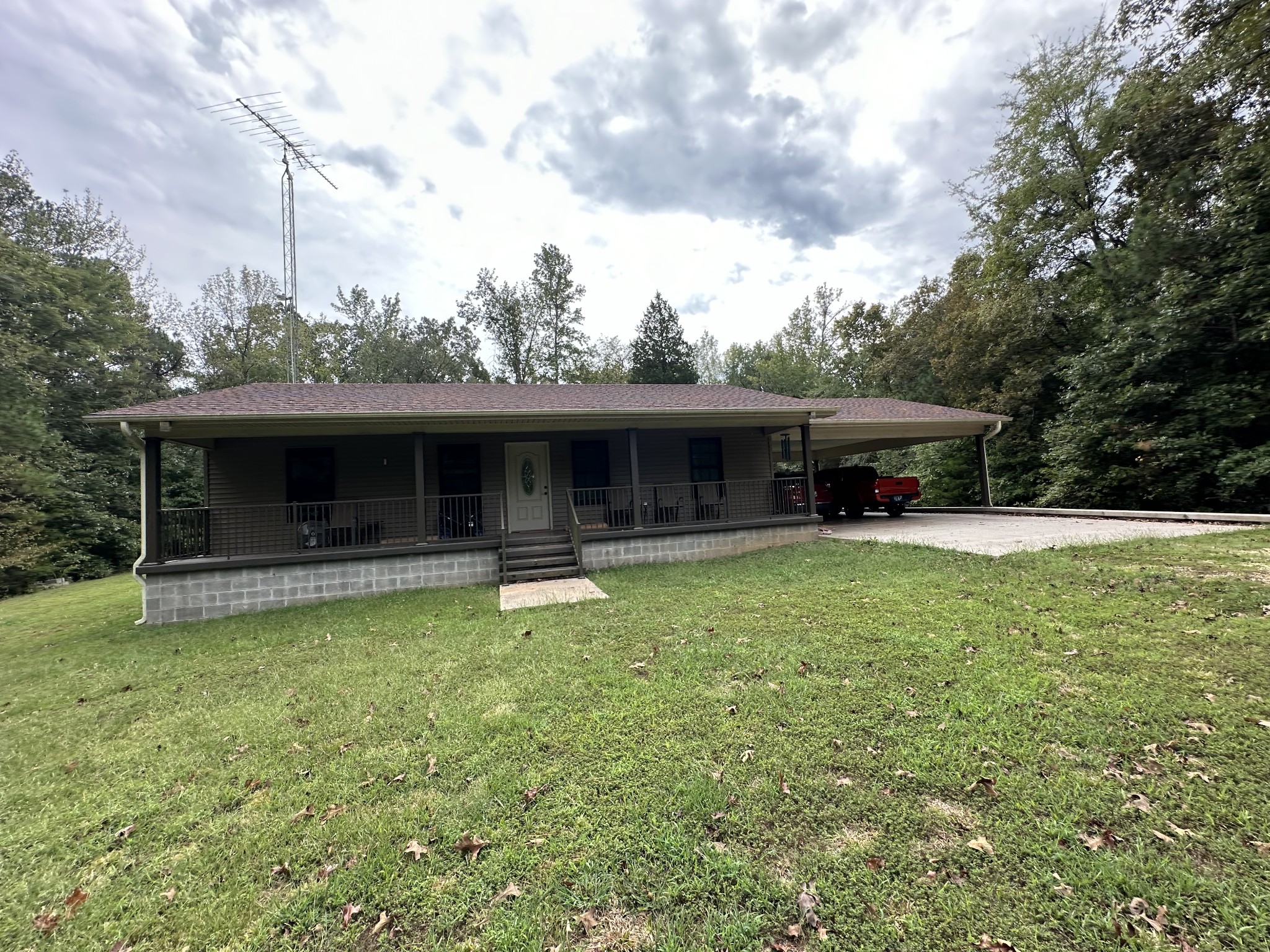 a view of house with backyard space and balcony