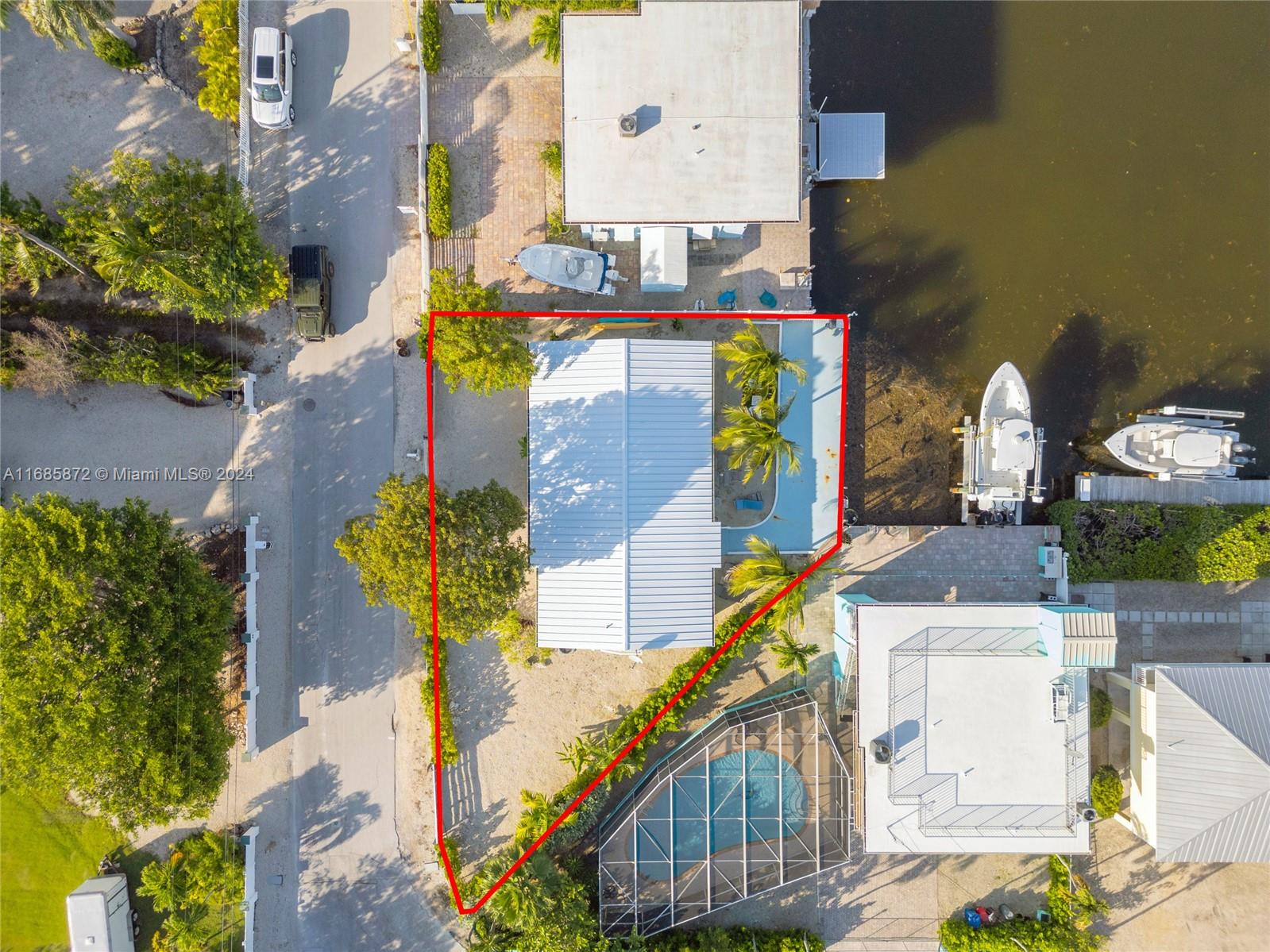 an aerial view of a house with a yard and a fountain