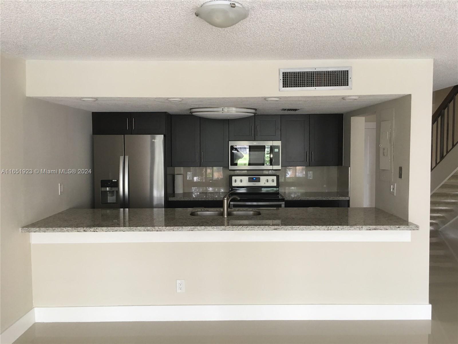 a view of kitchen with stainless steel appliances