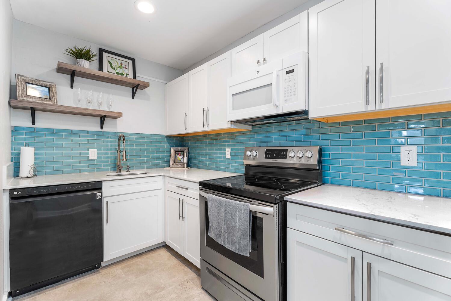 a kitchen with cabinets appliances and a sink