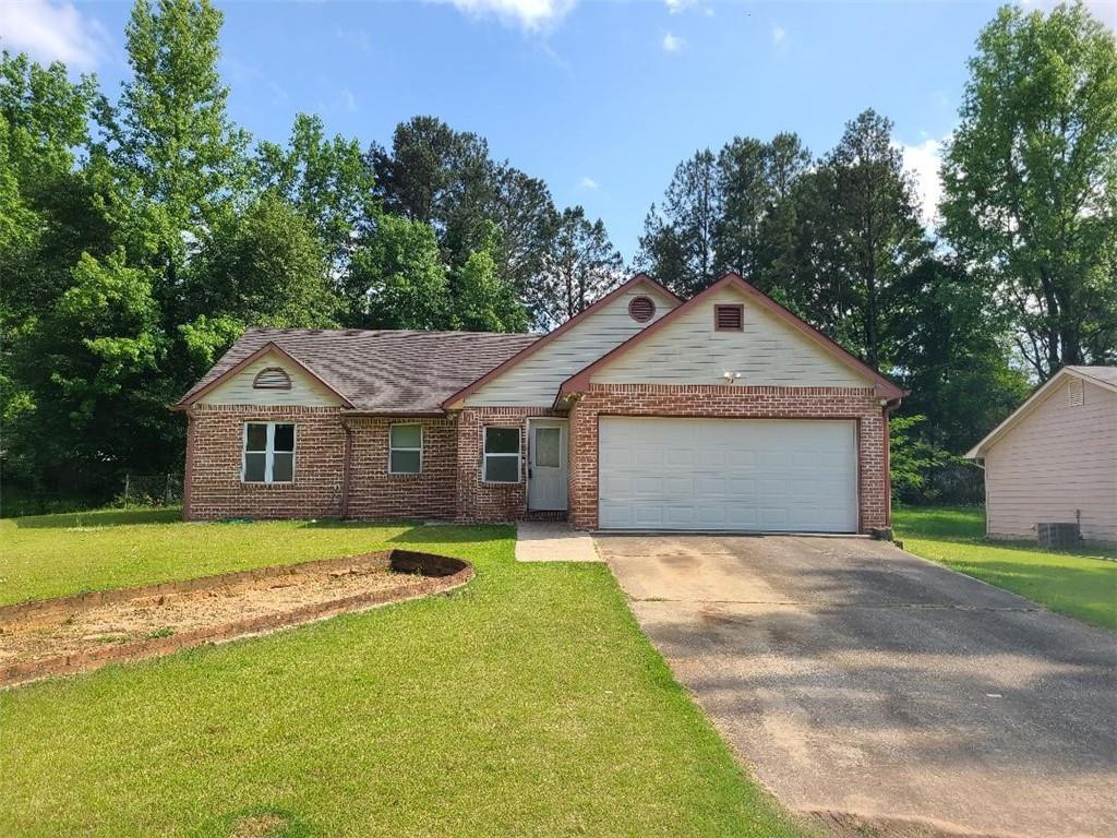 a front view of a house with yard and green space