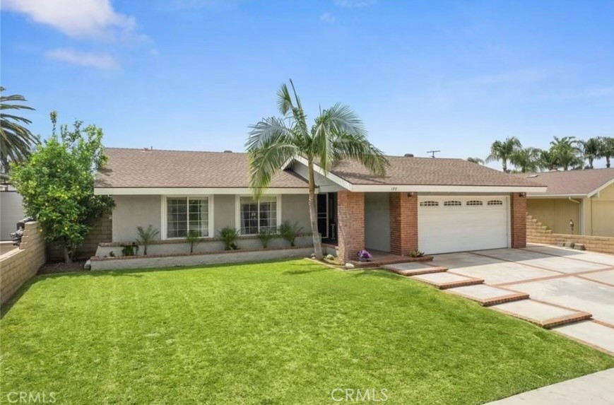 a front view of house with yard and outdoor seating