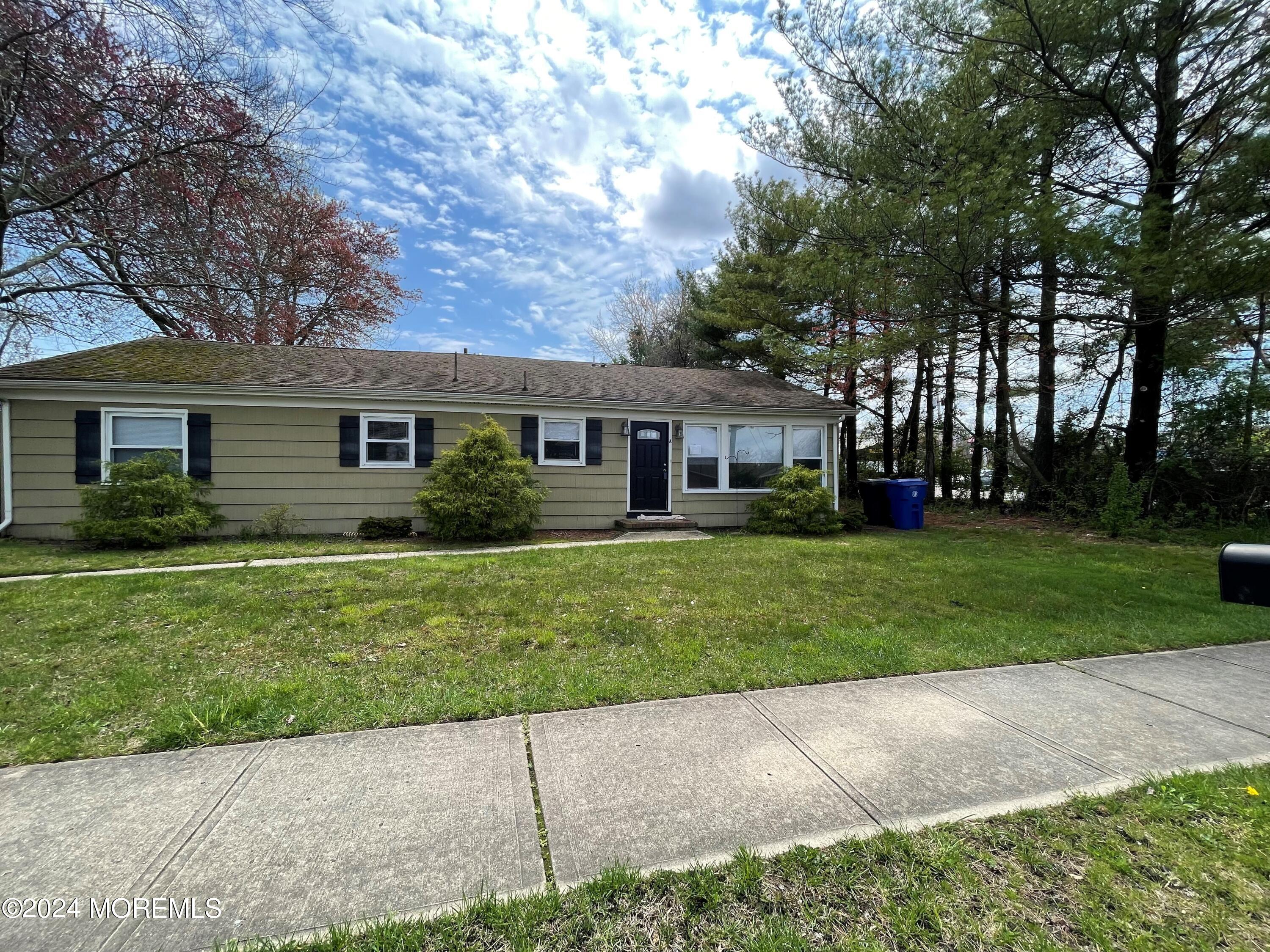 a front view of house with yard and green space