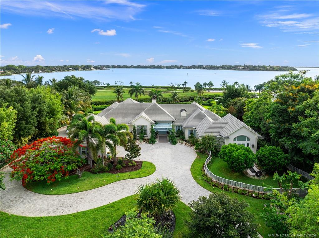 an aerial view of a house with garden space and outdoor seating