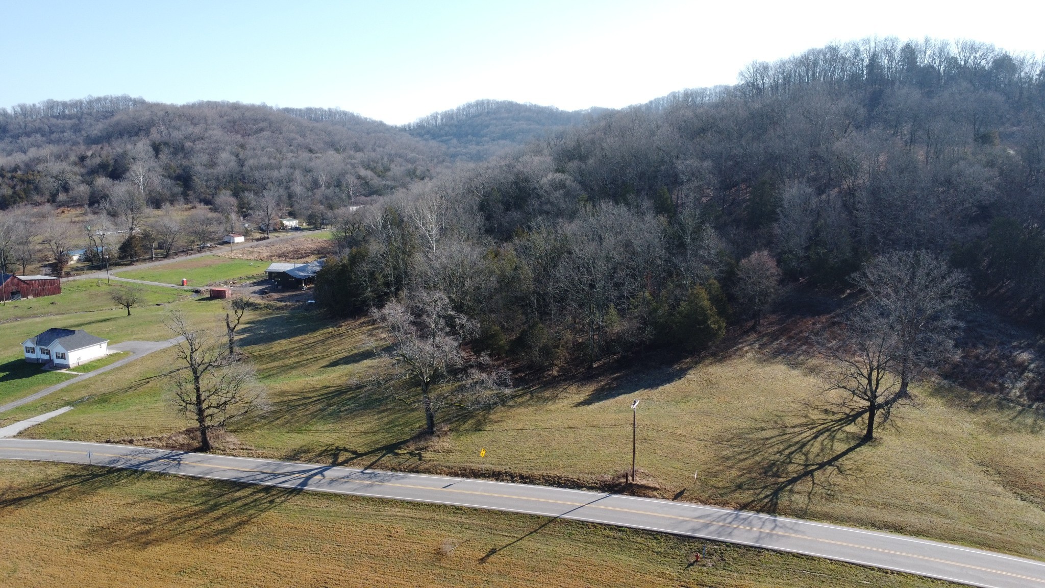 a view of a mountain with a yard