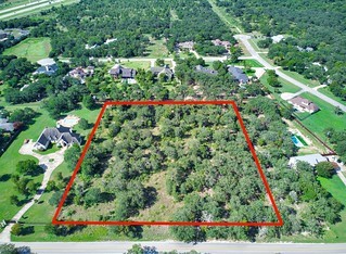 an aerial view of house with yard and outdoor seating