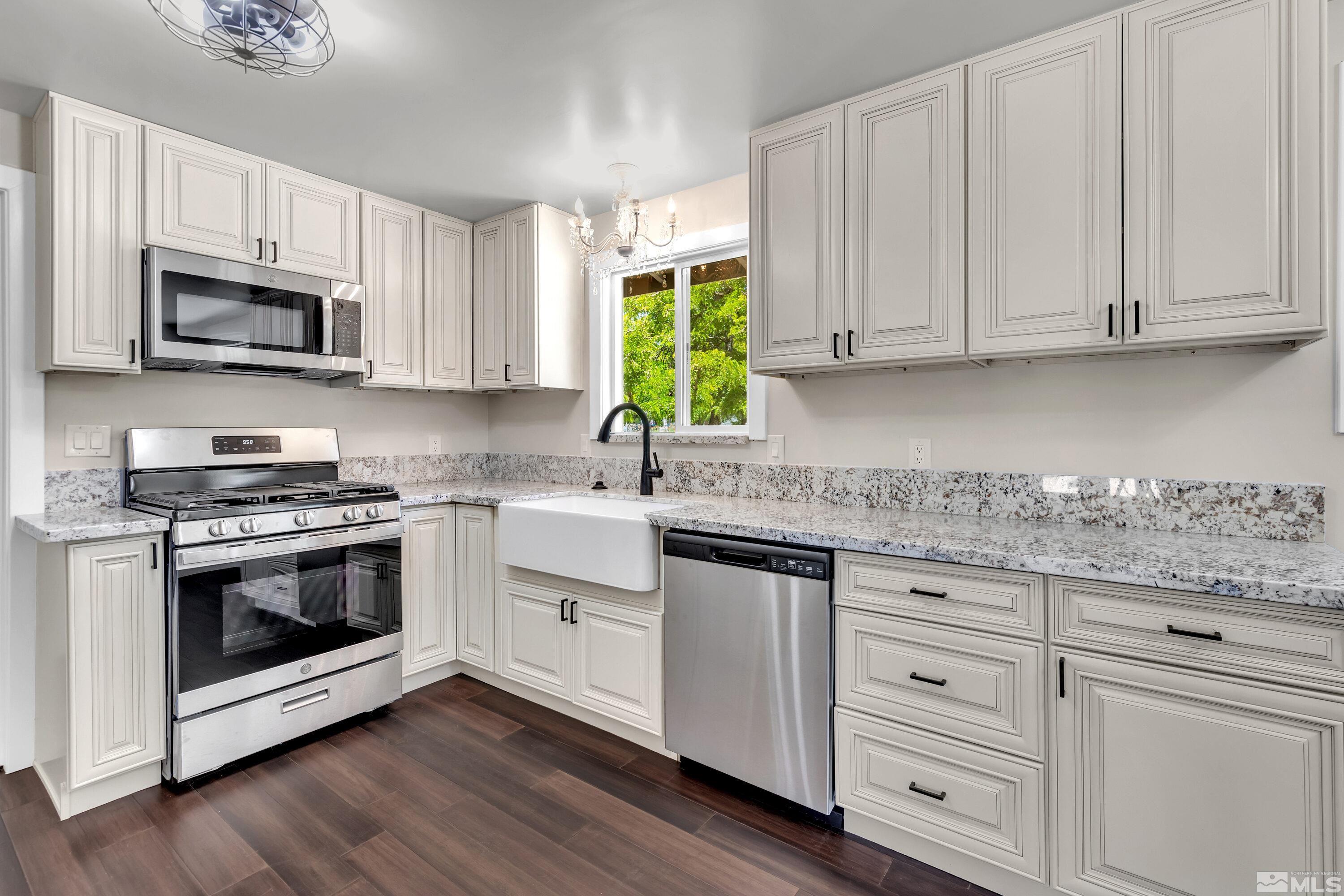 a kitchen with white cabinets and appliances