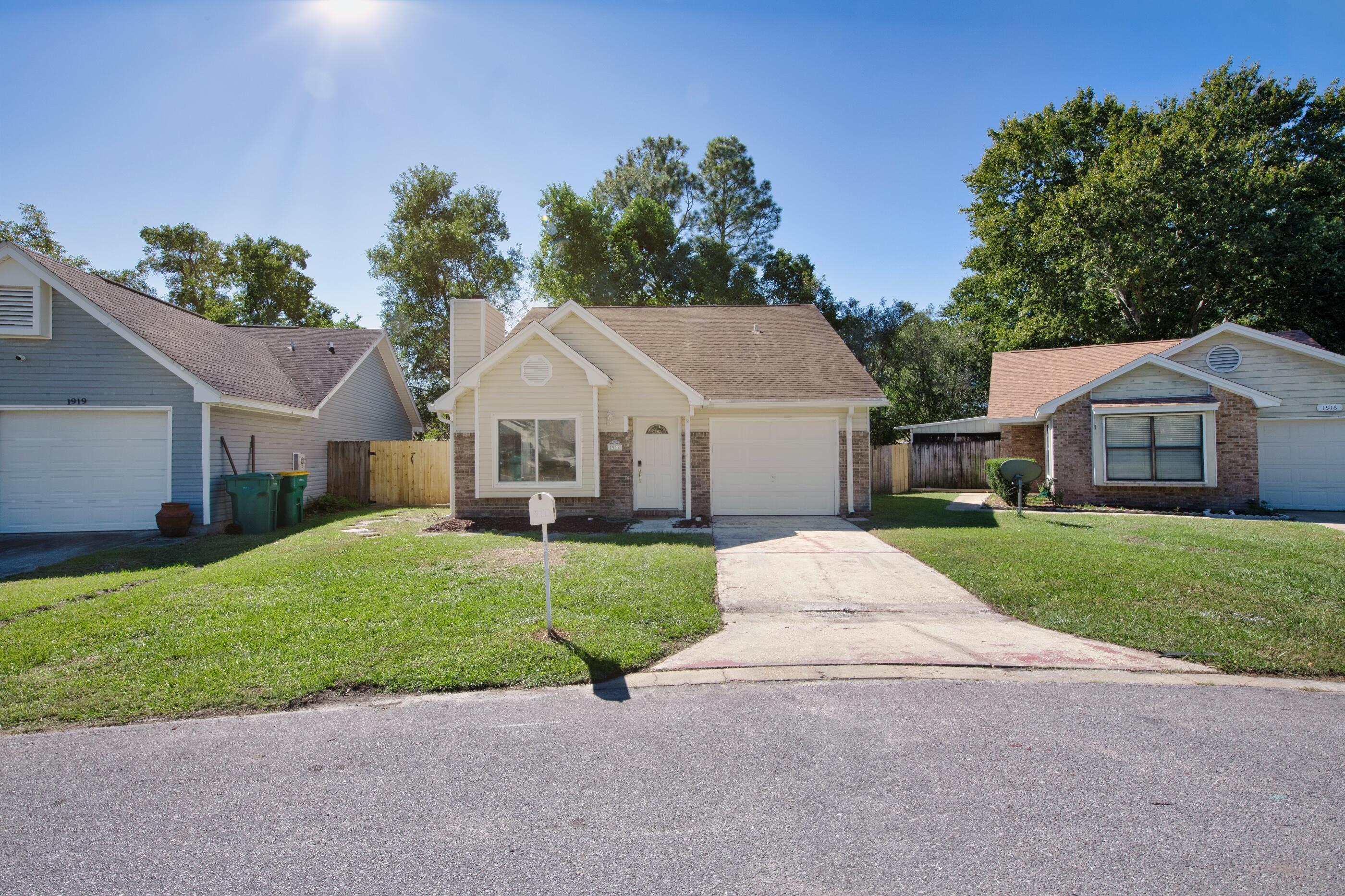 a view of a yard in front view of a house