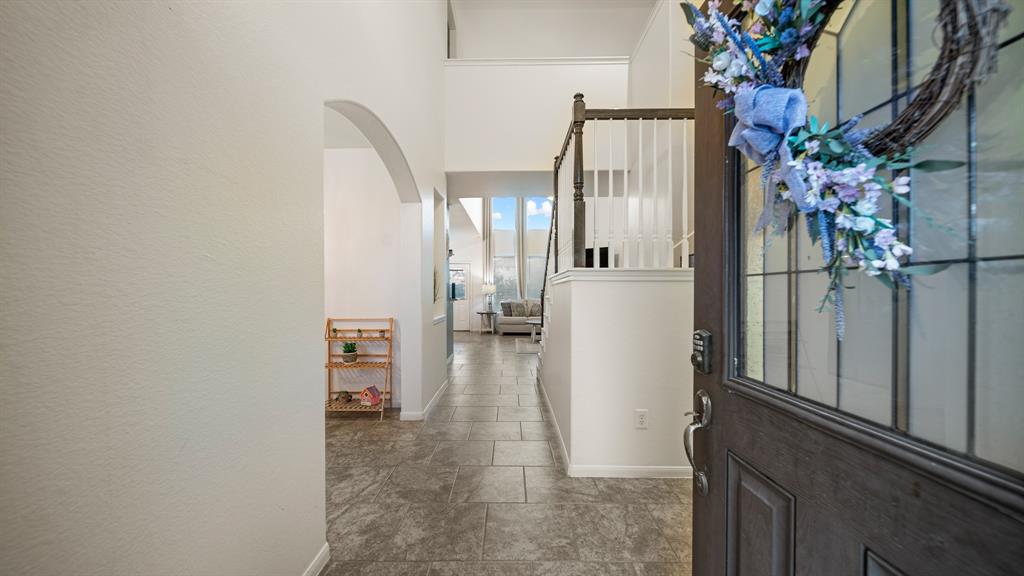 a view of a hallway to a livingroom with furniture