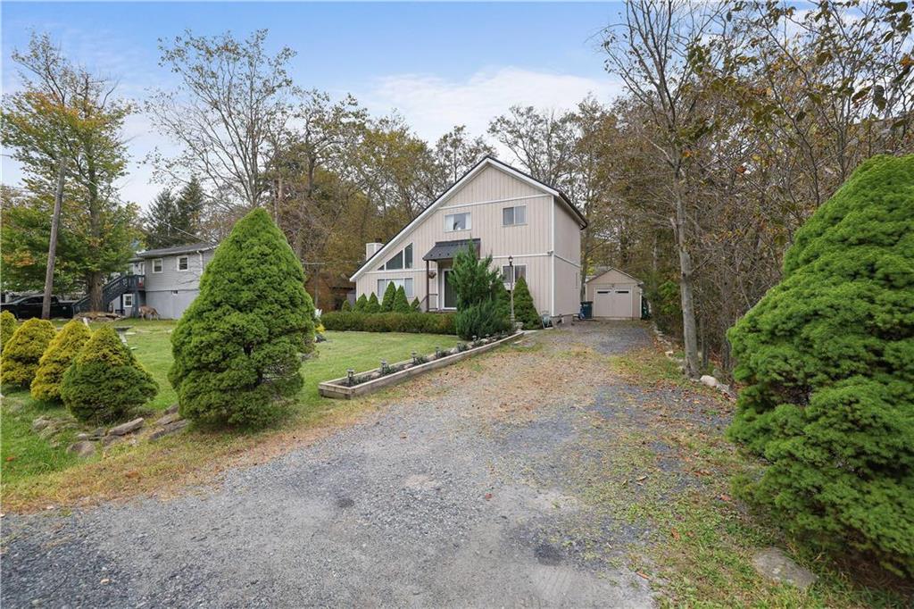 a view of a house with a yard and garage