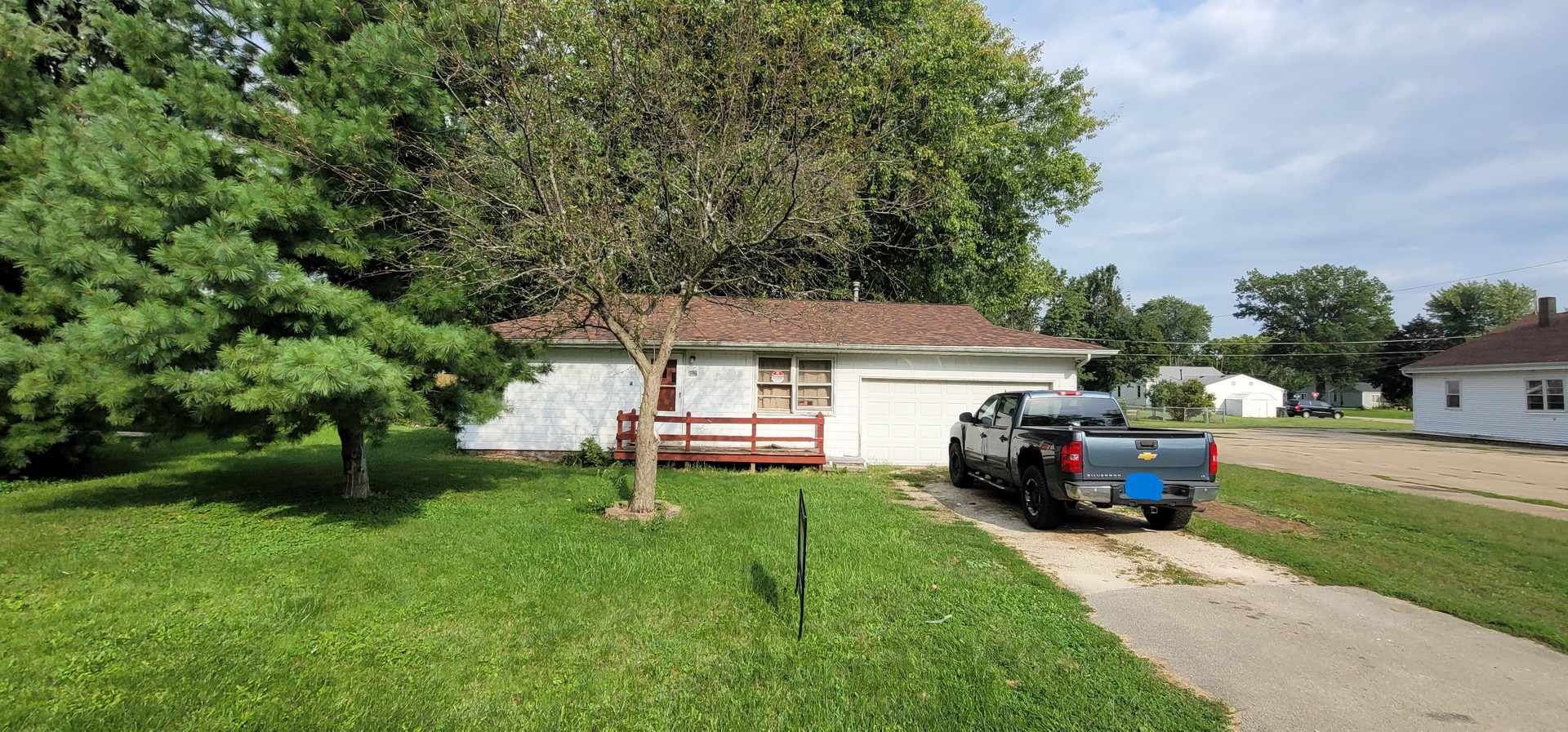 a view of a house with a yard and sitting area