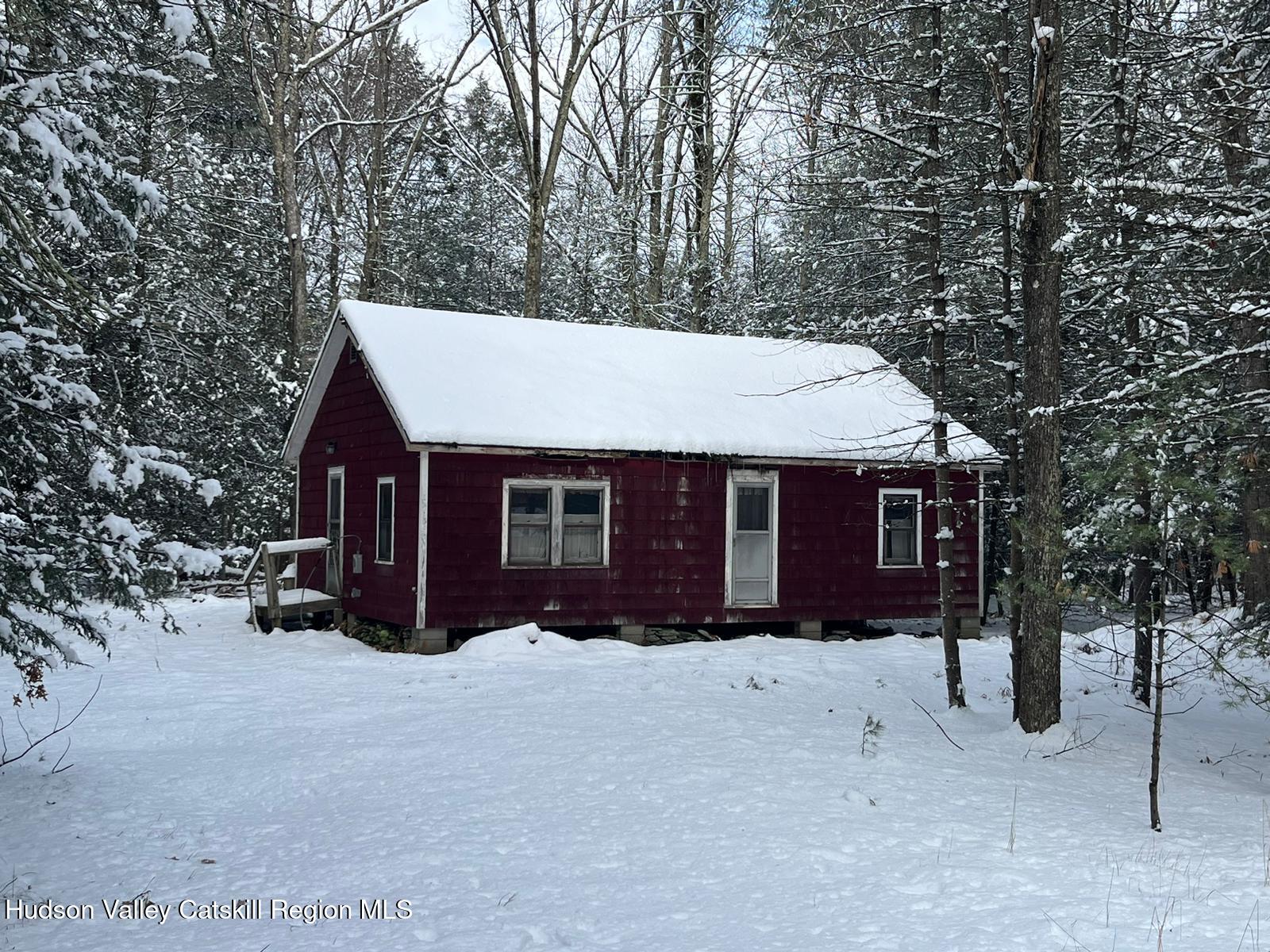 a view of a house with a yard covered in snow