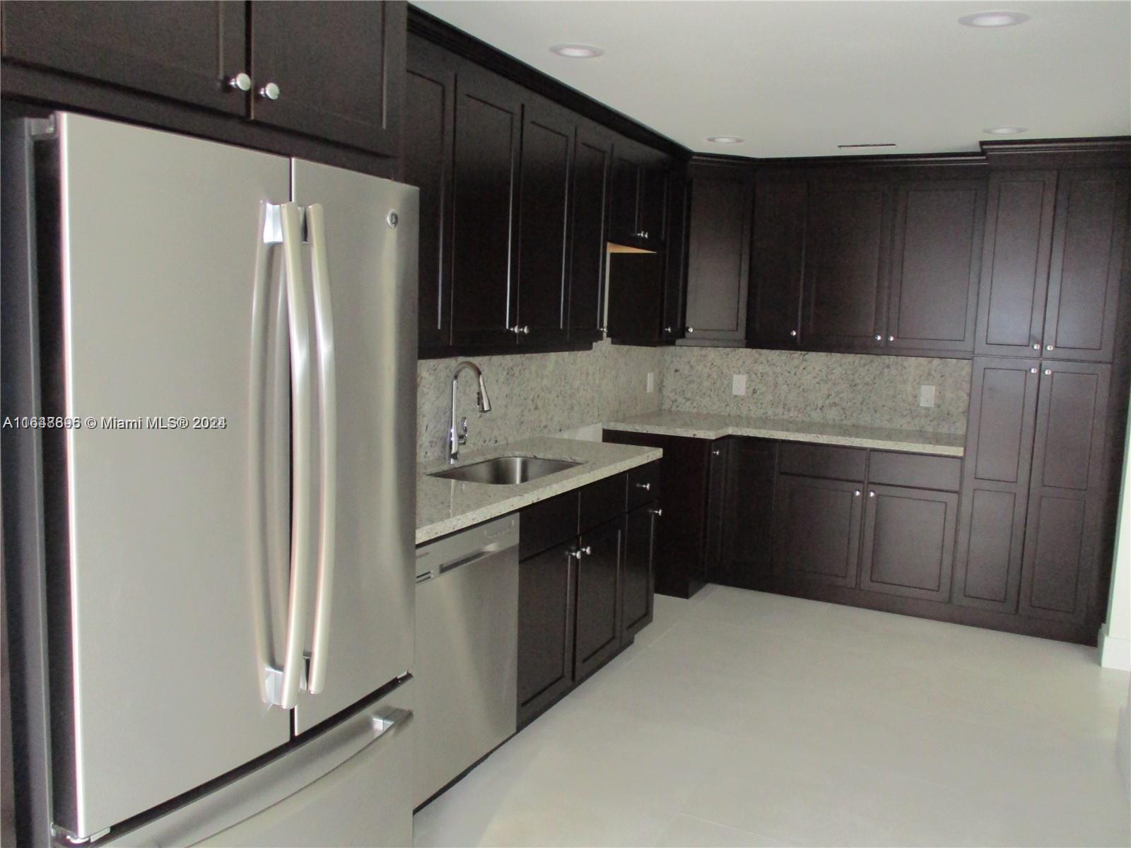 a kitchen with stainless steel appliances a refrigerator and a sink