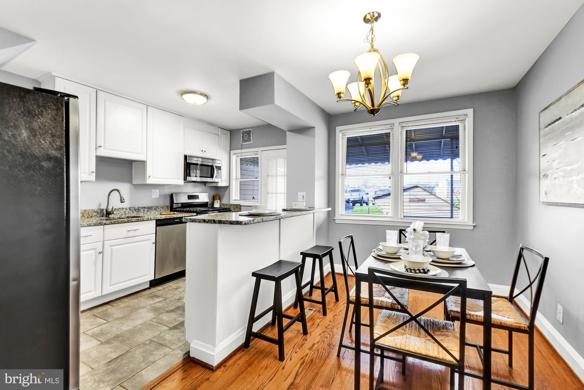 a kitchen with a table chairs and microwave