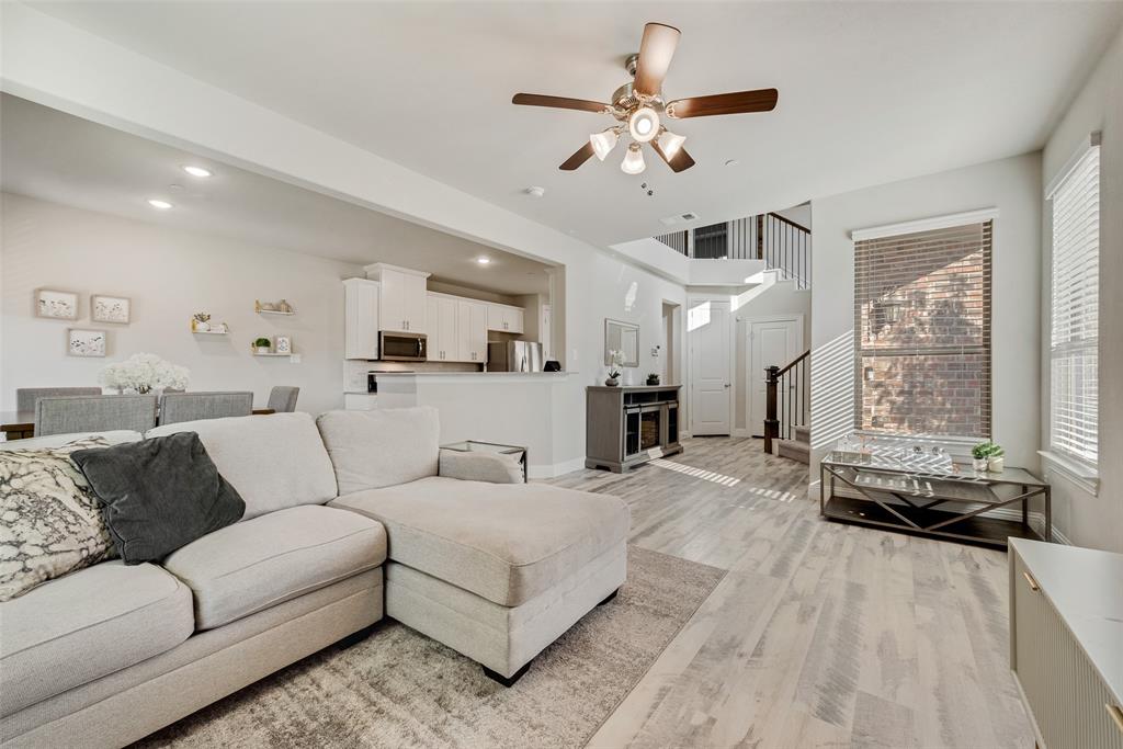 a view of a living room kitchen and a wooden floor