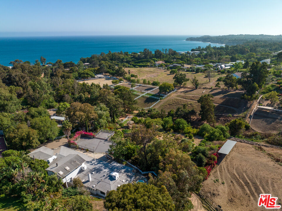 an aerial view of a houses with a yard