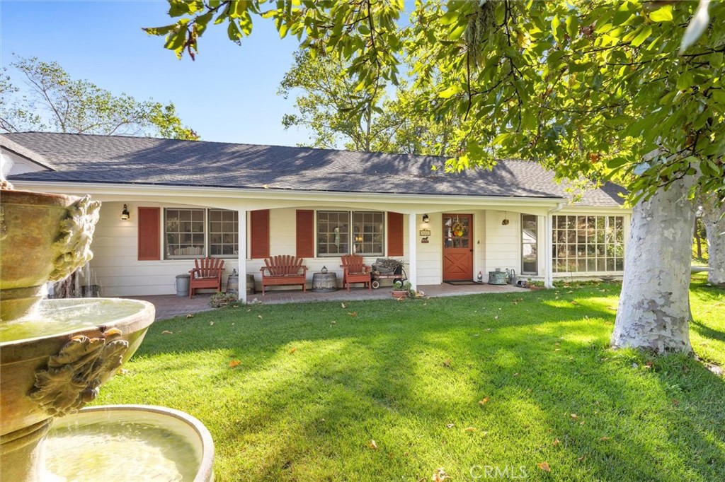 a view of a house with a backyard porch and furniture