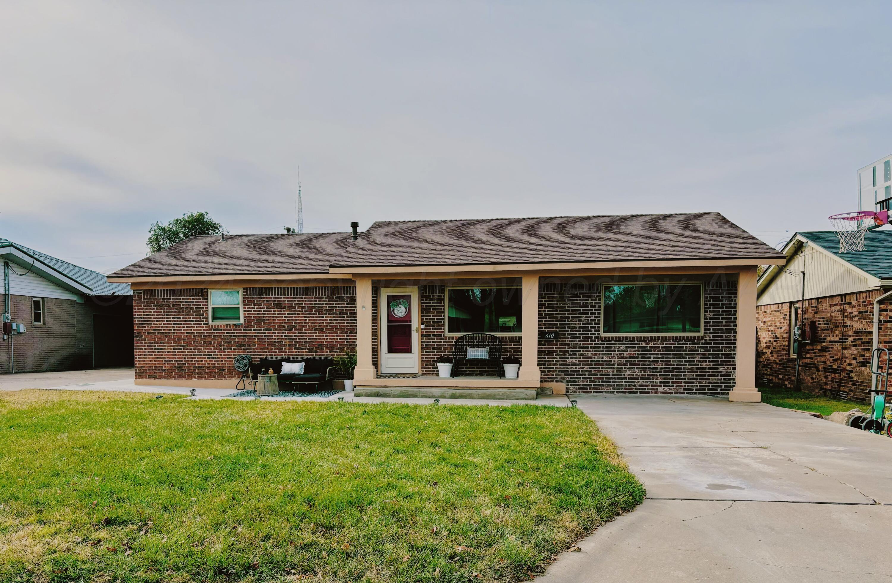 a front view of house with outdoor seating and yard