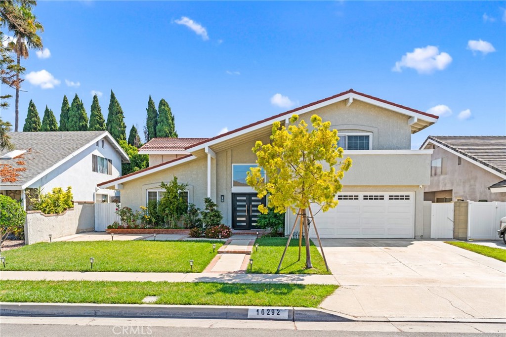 a view of a house with a yard and plants